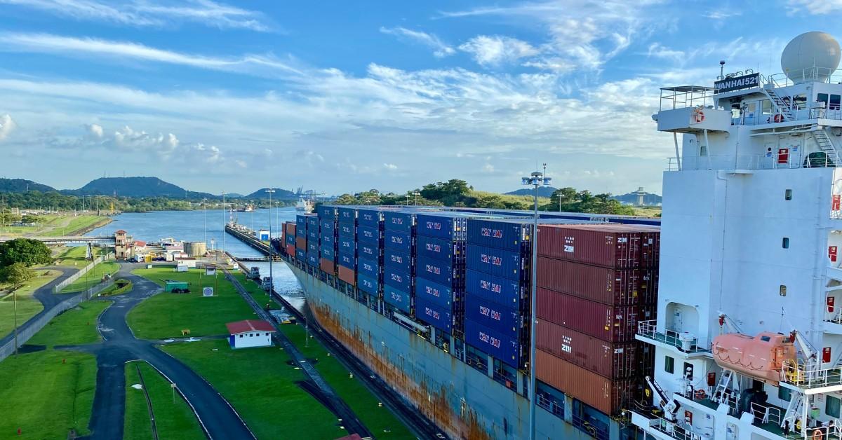 A cargo ship sits docked in the Miraflores Locks of Panama Canal