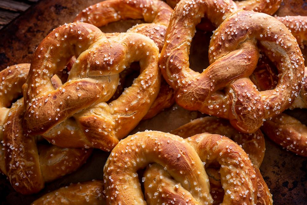 A close up of salted, soft, homemade pretzels. 