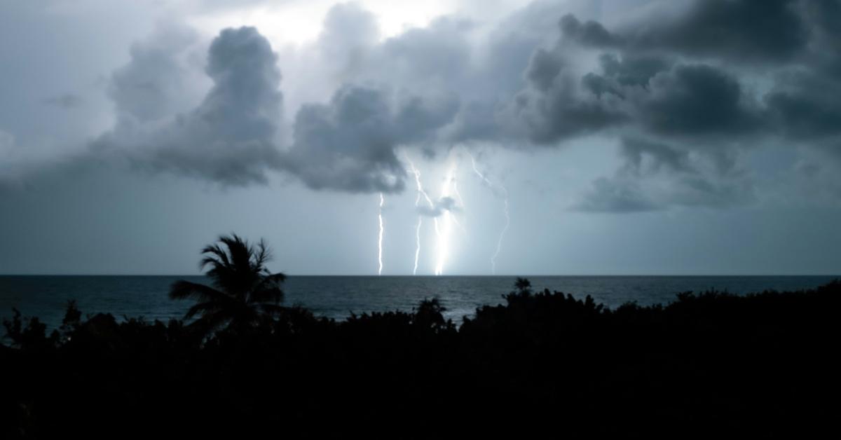 Lightning from a tropical storm strikes in the ocean.