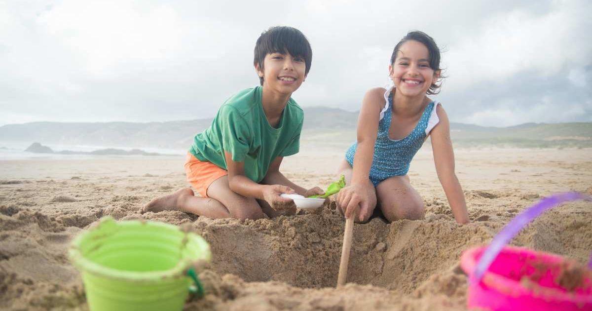A young girl and boy playing on the beach sand digging a hole. (Representative Cover Image Source: Pexels | Kampus Productions)