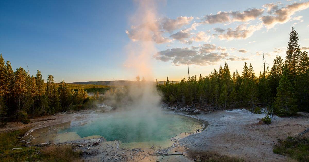 Billowing plume of steam rising from the Norris hot spring in Yellowstone (Representative Cover Image Source: Getty Images | Putt Sakdhnagool)
