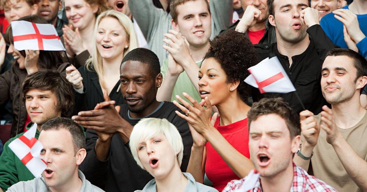 People cheering at a sporting event. 