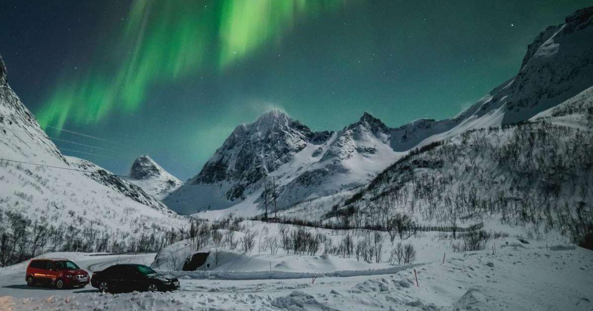 Tourists in cars drive by a mountain to watch the breathtaking aurora borealis in Norway. (Representative Cover Image Source: Pexels | Tobias Bjorkli)