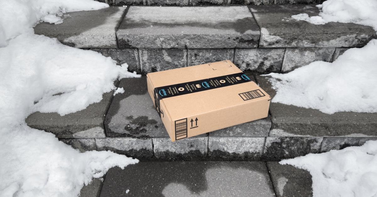 Amazon package on snow covered ground. 