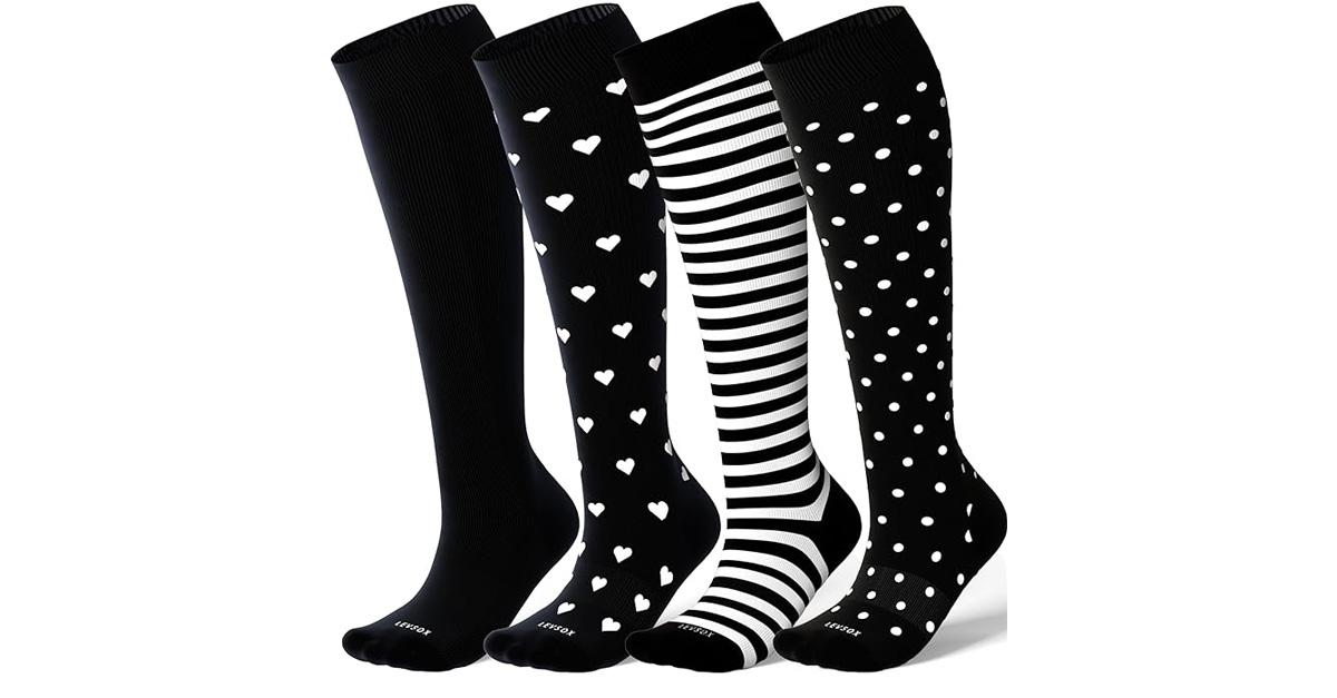 four pairs of knee high compression socks in black and white patterns and solids