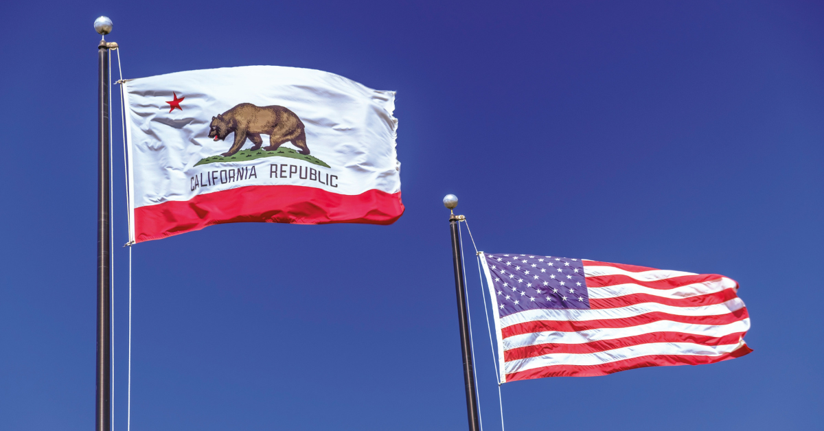 A California state flag flies next to a U.S. one