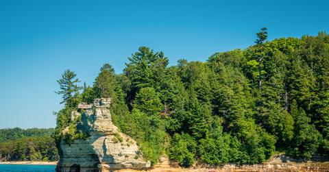 The bright blue waters and tall, rocky cliffs of Pictured Rocks National Lakeshore in Michigan