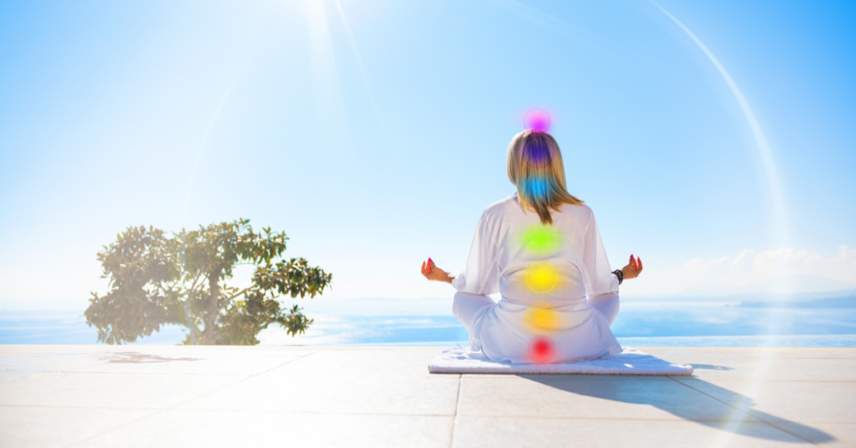 Photo of a woman meditating while Reiki chakras are highlighted 