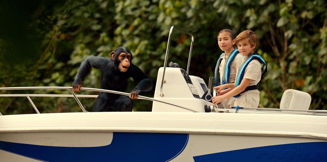 A scene from 'Jane' with two kids and a chimpanzee on a boat