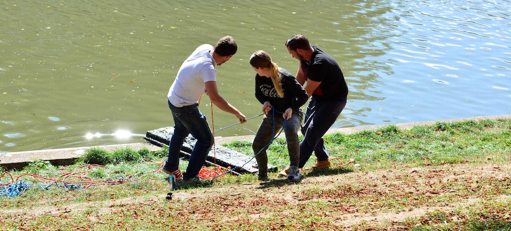 Three adults magnet fishing in the U.K. 