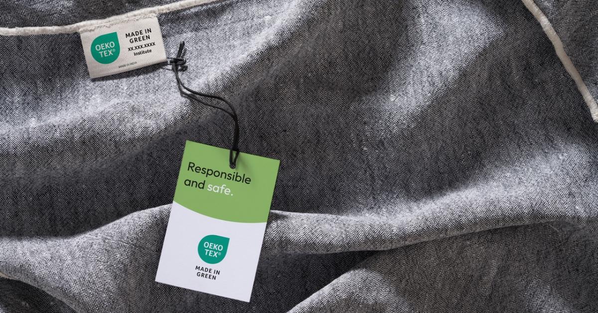 Close-up photograph of a grey clothing item with the Made in Green label.