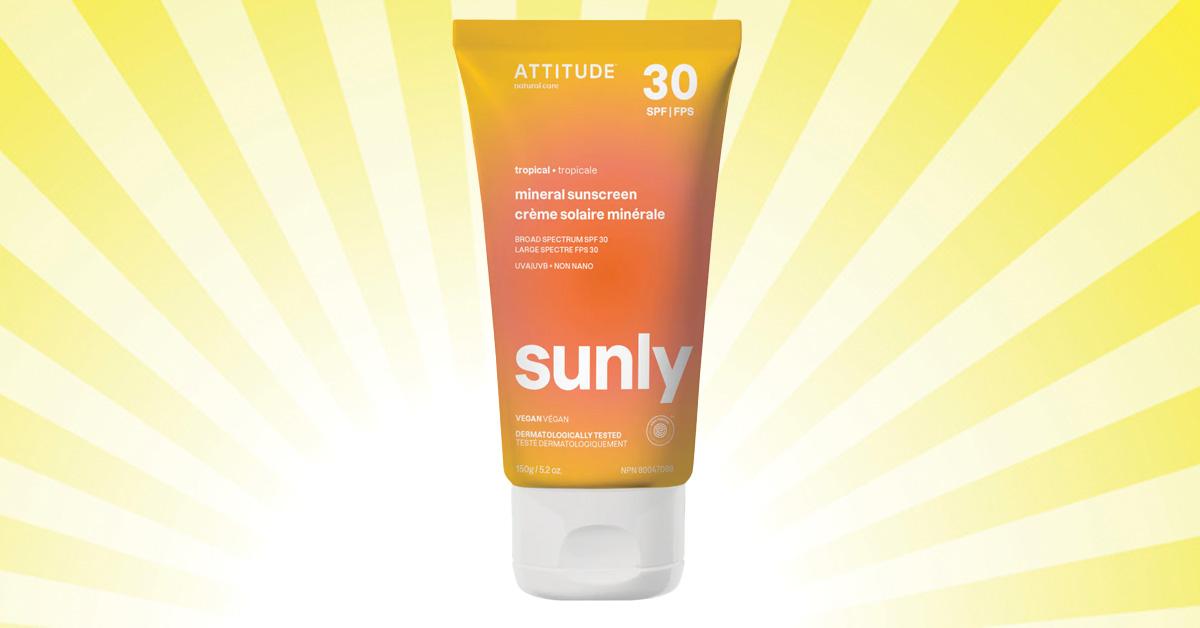 Orange bottle of sunscreen against a yellow sunny background