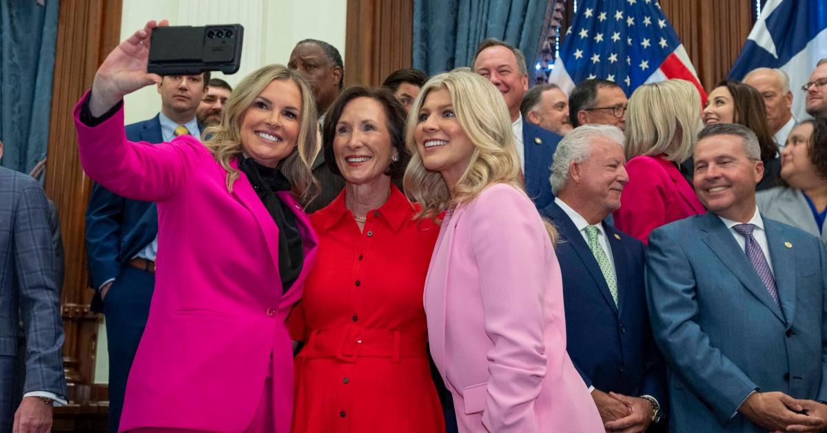 Politicians pose for a selfie after Greg Abbott signs a bill regulating additives to foods 