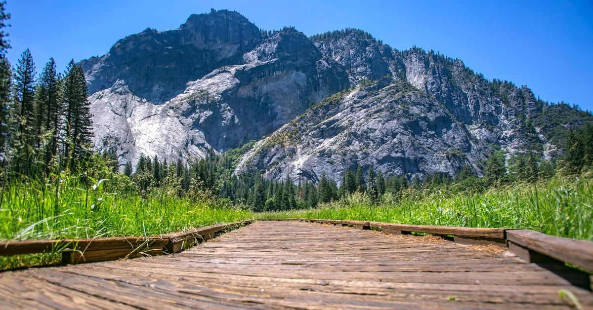 A wood path leading to Yosemite National Park with a mountain in the background