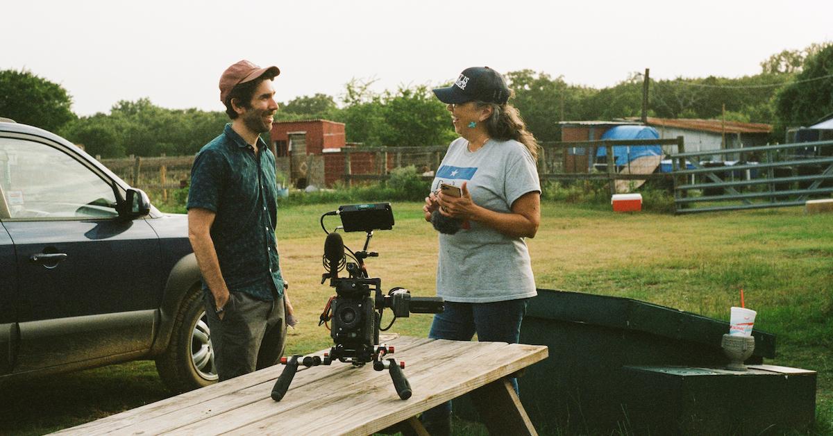 Jason Goldman and Renee King-Sonnen talk to each other outside, with a video camera in the foreground.