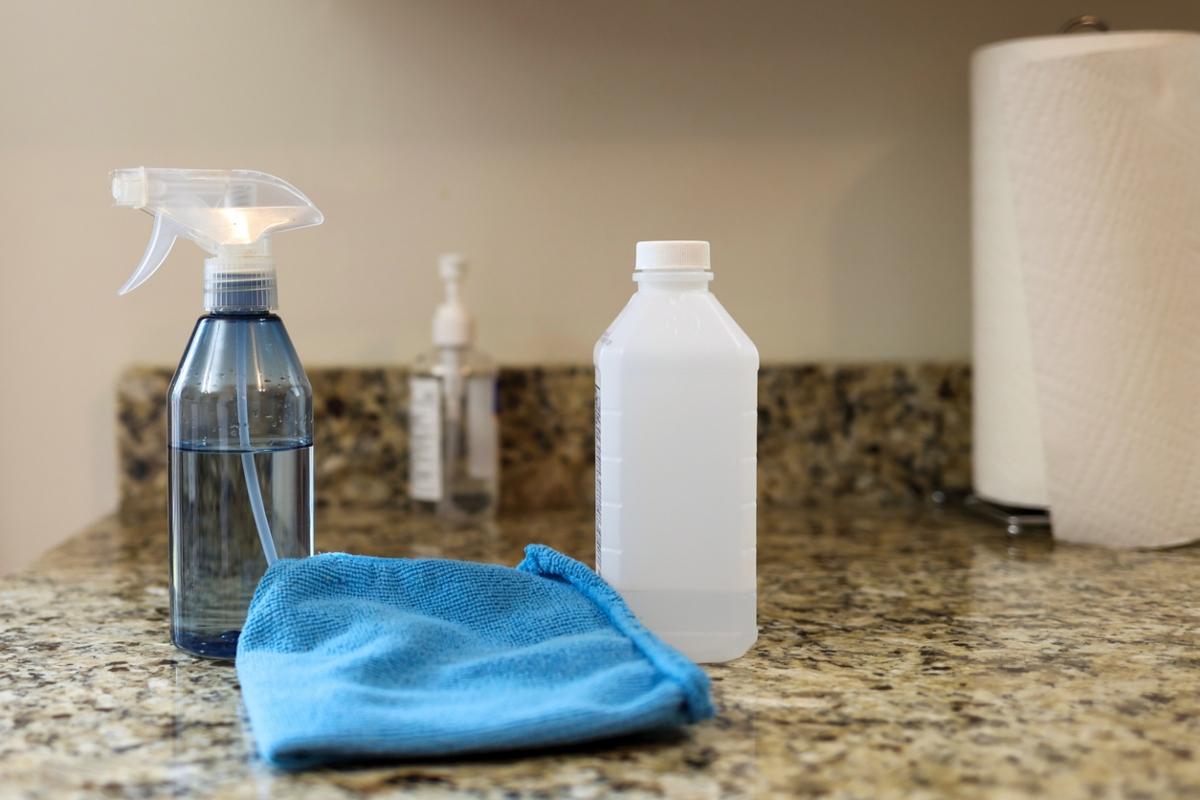 rubbing alcohol and spray bottle of cleaner on countertop