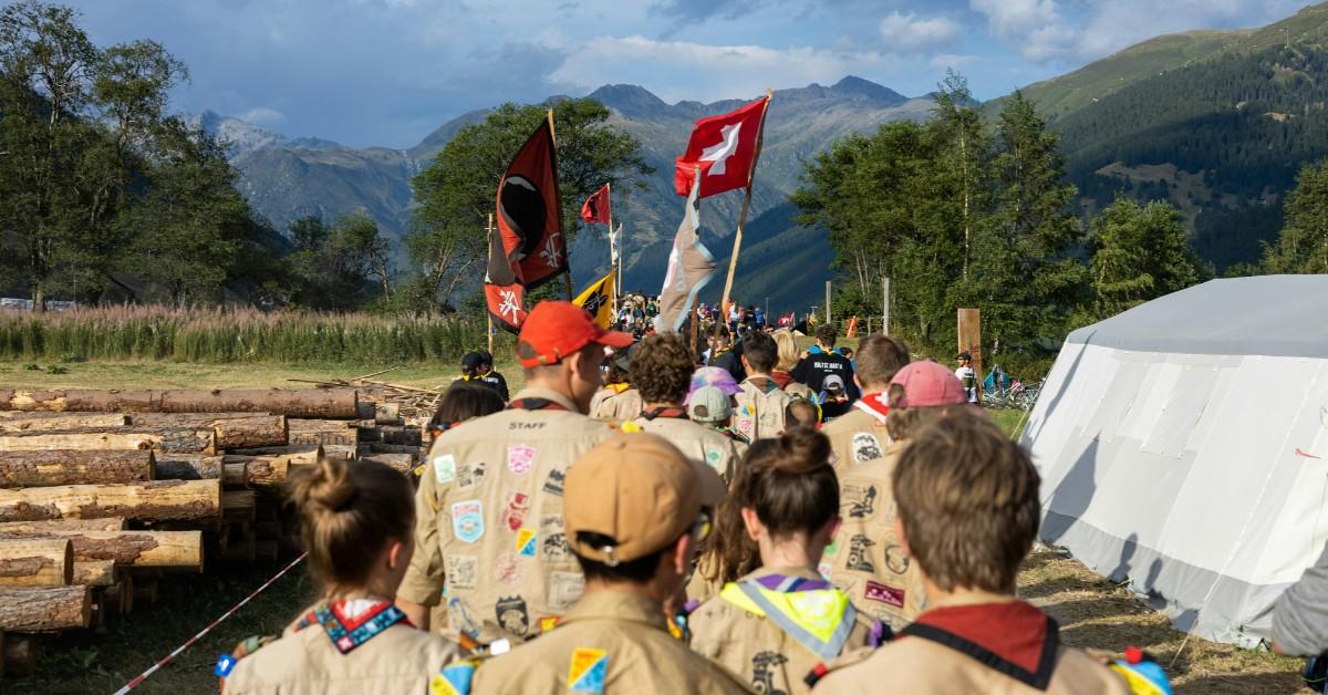 A group of scouts walk down a road