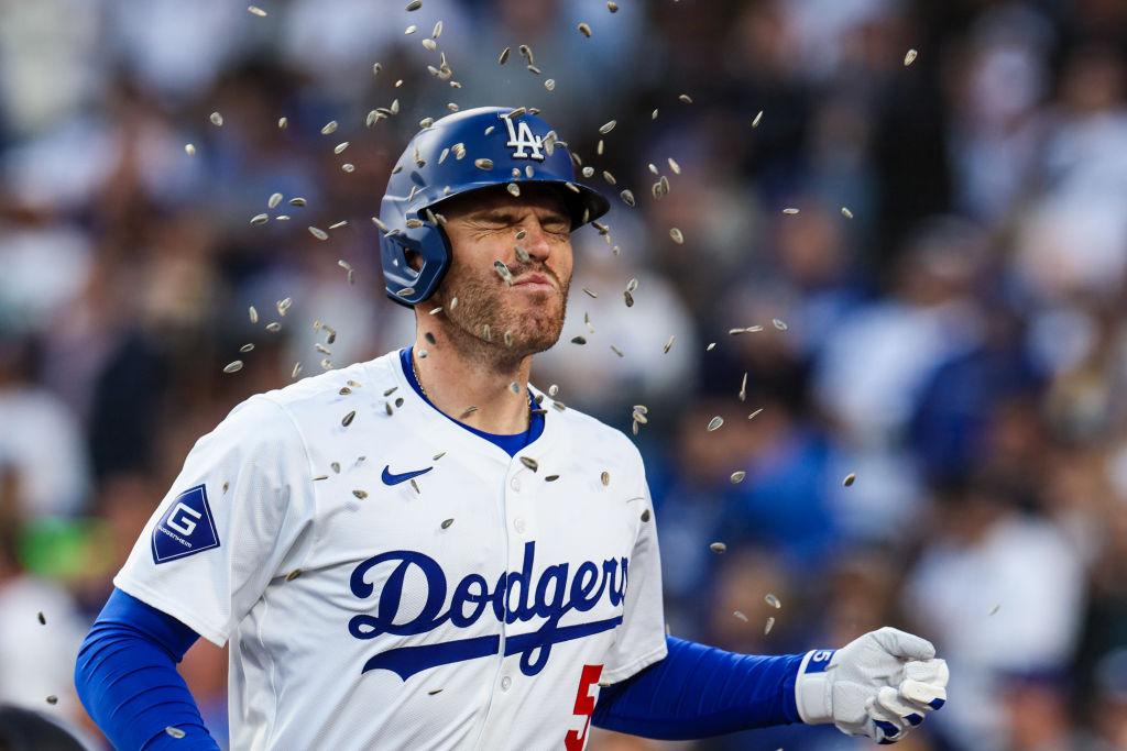 Los Angeles Dodgers first base Freddie Freeman is showered with sunflower seeds in celebration after hitting a home run.