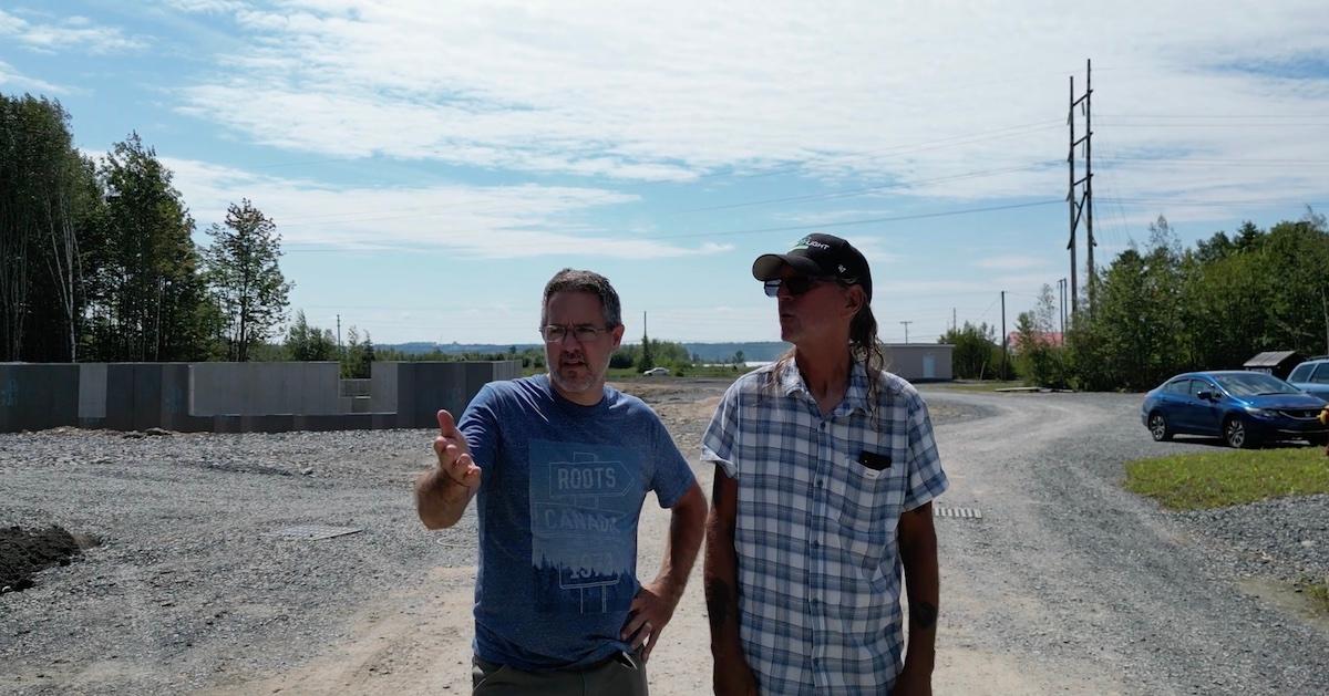 Marcel Lebrun and another man stand on the tiny home site