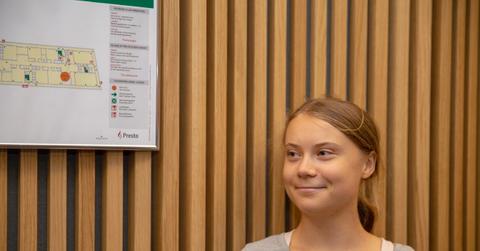 Greta Thunberg smiling while in court.