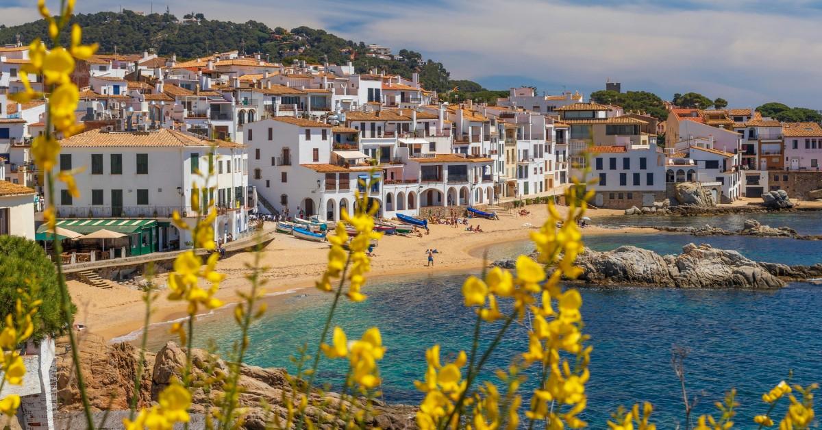 White buildings stand out against the blue of the ocean in Palafrugell, Spain