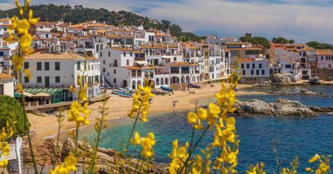 White buildings stand out against the blue of the ocean in Palafrugell, Spain