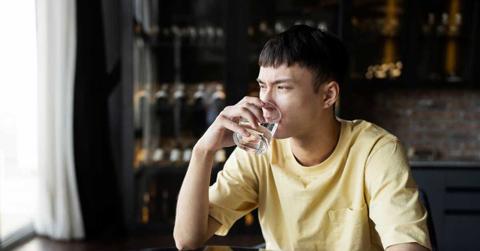 A man scrunches his face while drinking water from a glass. (Representative Cover Image Source: Freepik)