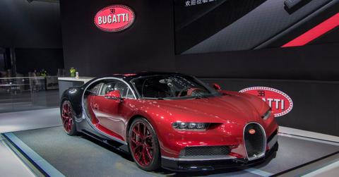 A red Bugatti Chiron on the showroom floor.