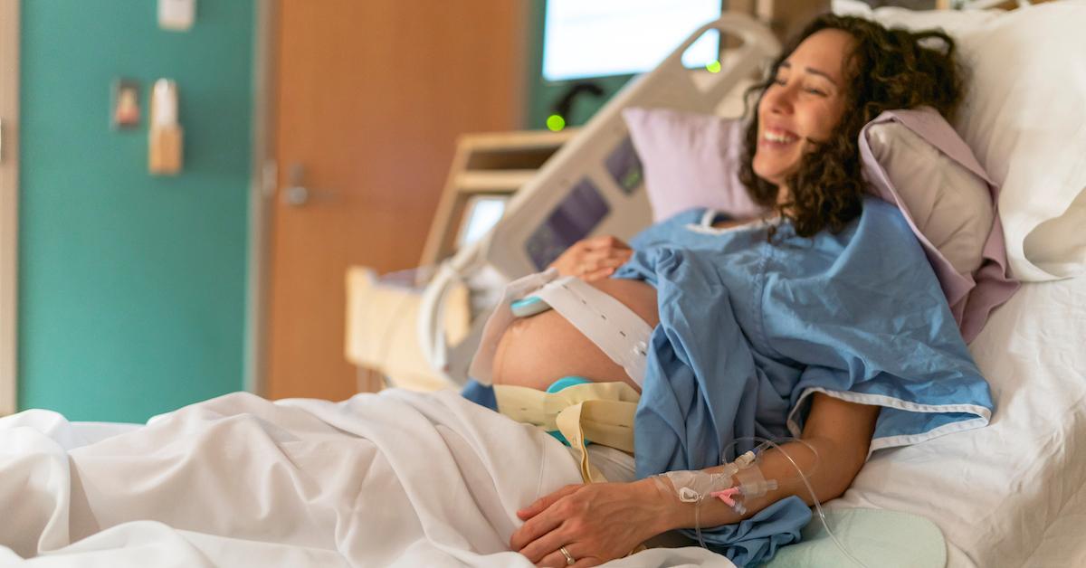 A woman in labor on a hospital bed