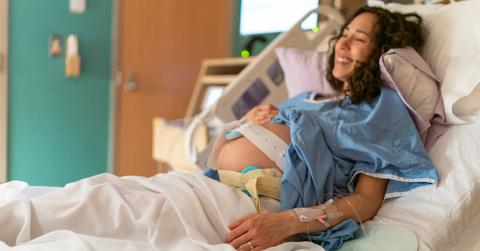 A woman in labor on a hospital bed