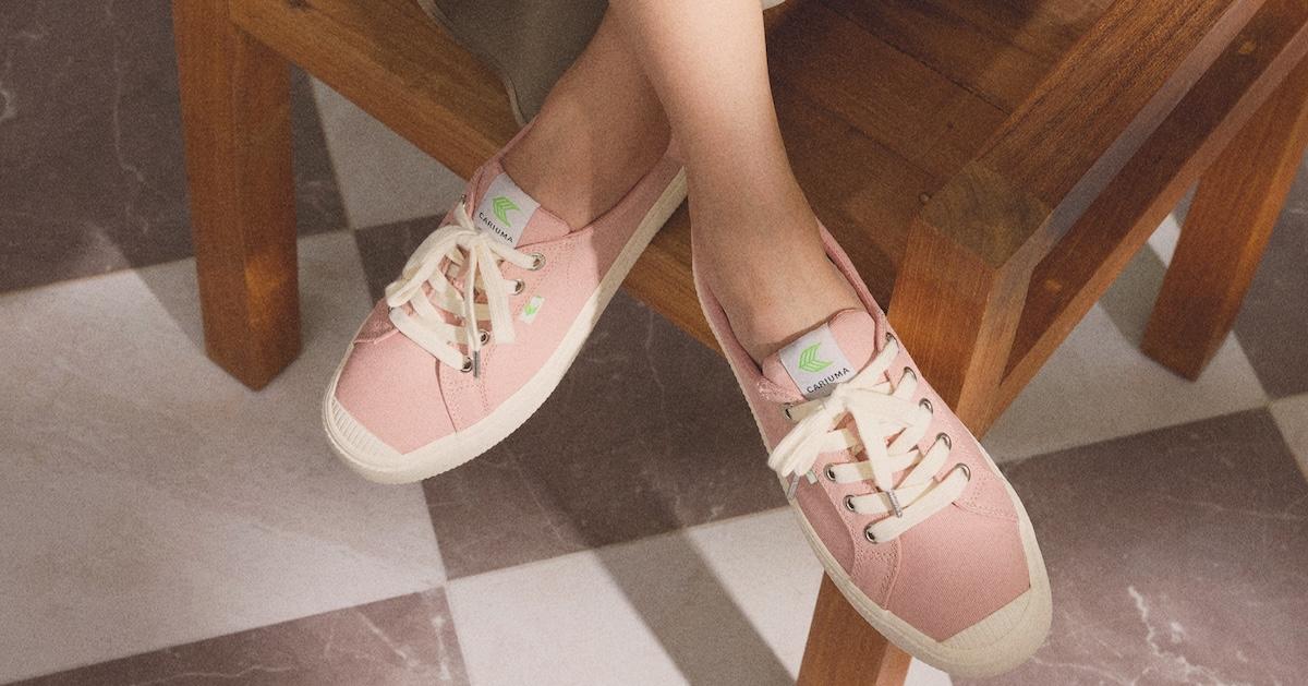 Pink Cariuma sneakers on person's feet