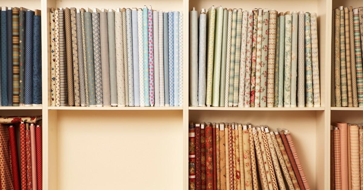 Closeup of multiple fabric reams stocked on a shelf