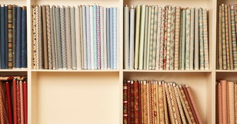 Closeup of multiple fabric reams stocked on a shelf