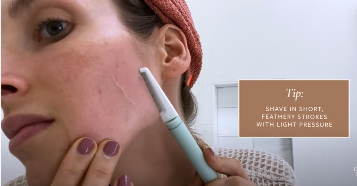 Dr. Sam Ellis uses dermaplaning tool on cheek