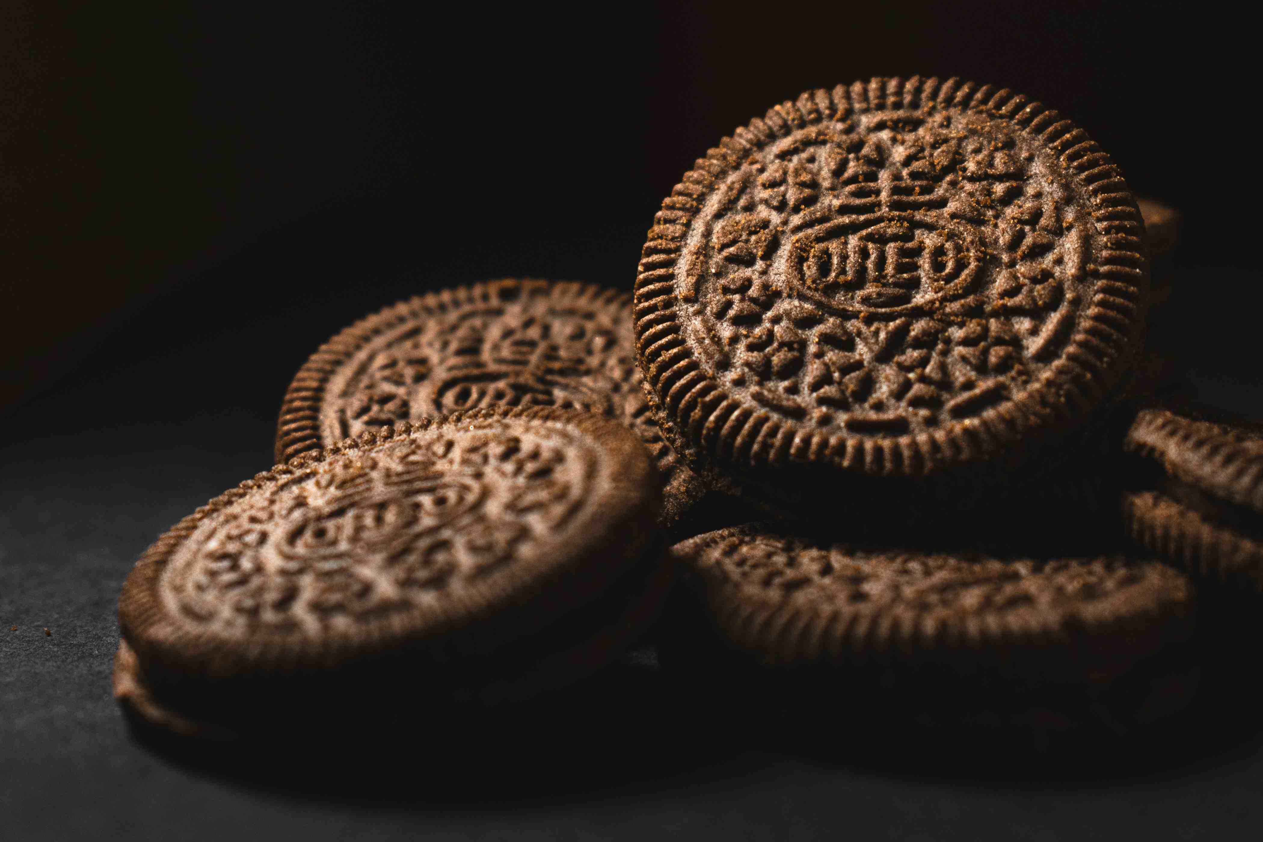 Several OREO cookies are stacked atop one another.