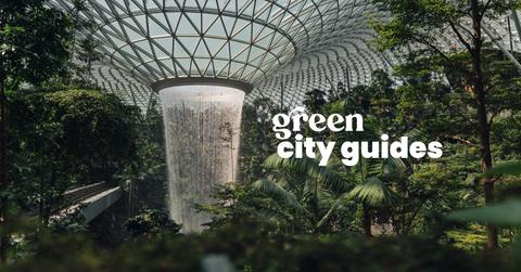 A waterfall inside a botanical garden with the text "green city guides."