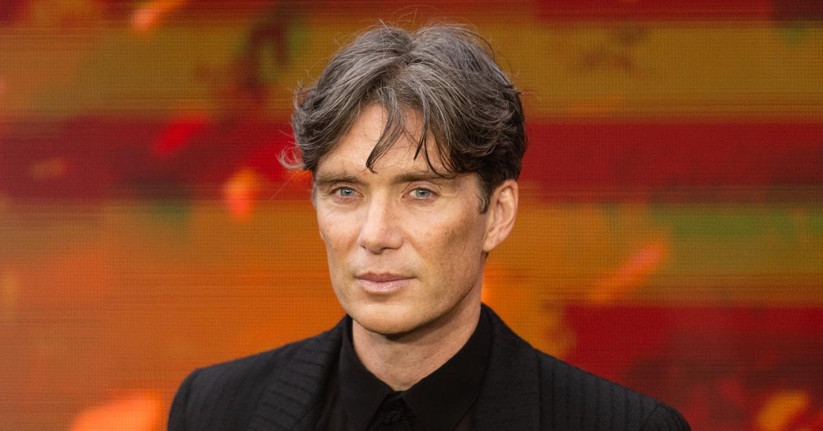 Cillian Murphy looks at the camera while posing at an "Oppenheimer" event.