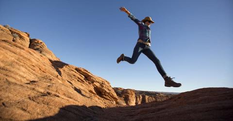 Man jumping over a canyon stretch with excitement in Grand Canyon National Park (Representative Cover Image Source: Getty Images | Jordan Siemens)