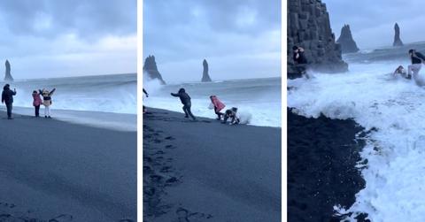 Tourists at Iceland's Black Sand Beach begin taking photos of the waves before running away from them and eventually falling from the force of the waves.