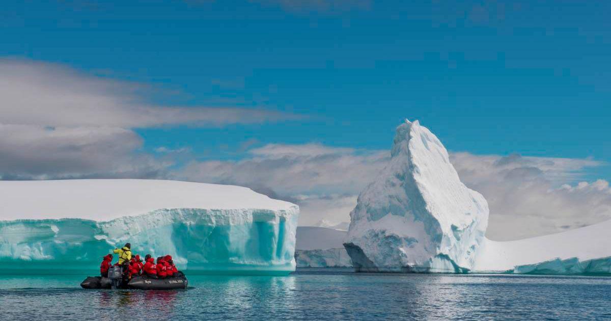 People are seen observing a huge glacier. (Representative Cover Image Source: Getty Images | Marie Hickman)