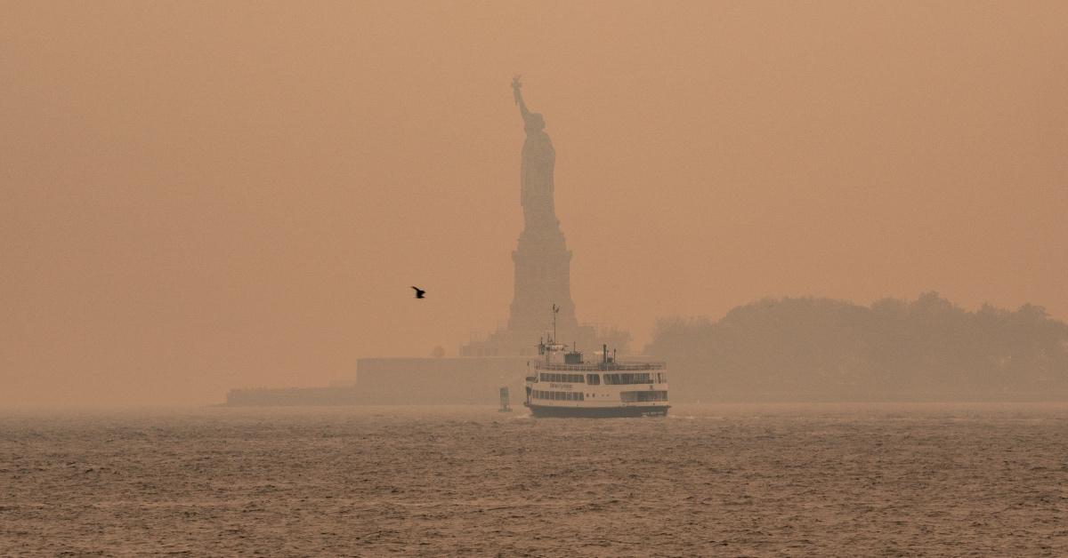 Photo of the Statue of Liberty as smoke from the Canadian wildfires covers New York City.