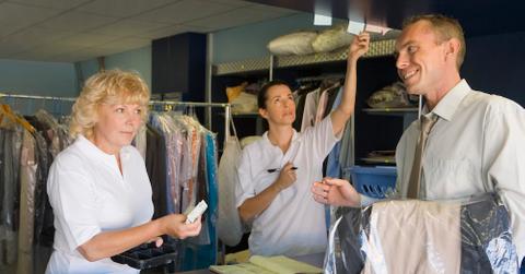 Three people at a dry cleaning shop