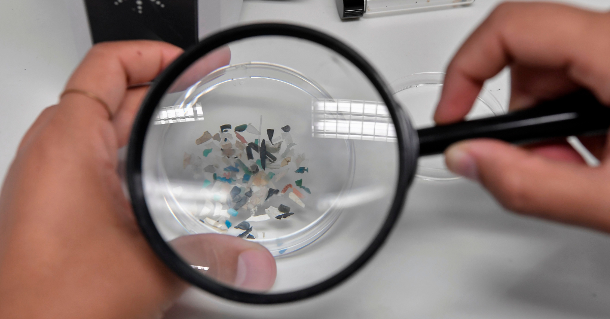 Magnifying glass looking at microplastics