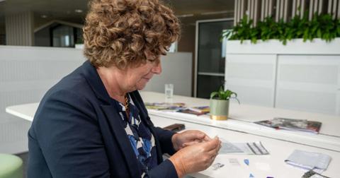 Vice prime minister De Sutter looking at blood tests in Brussels.
