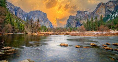 Gorgeous Merced River sparkling against the contrast of marigold golden sky and rugged mountain cliffs (Representative Cover Image Source: Getty Images | Travelview)