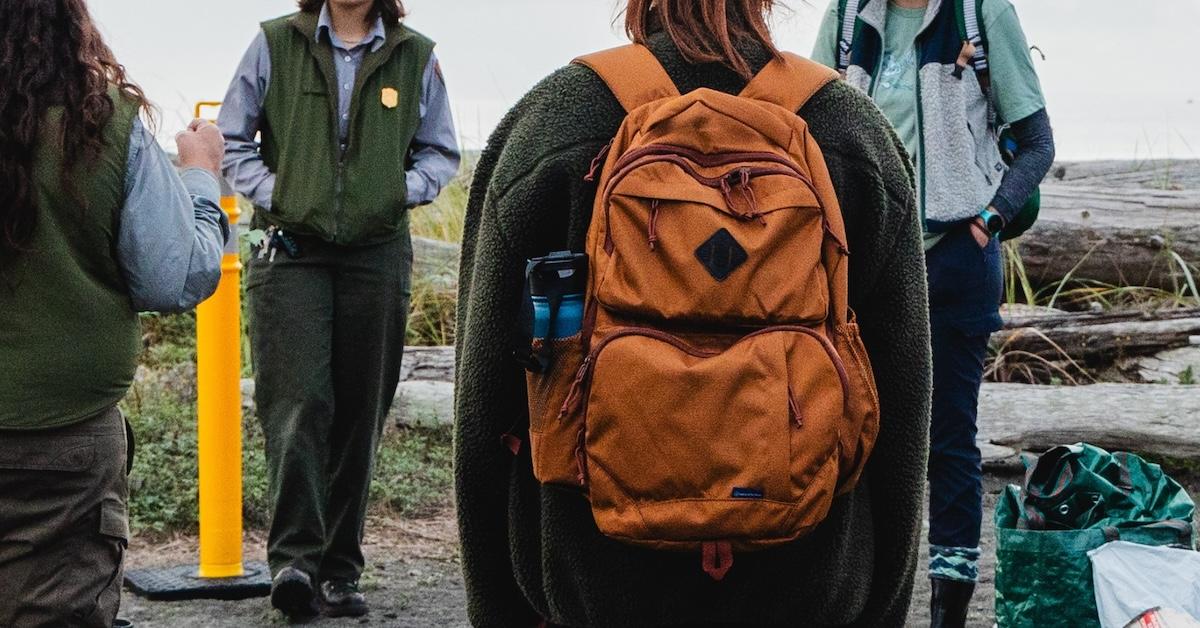 Back of person wearing United by Blue backpack outside