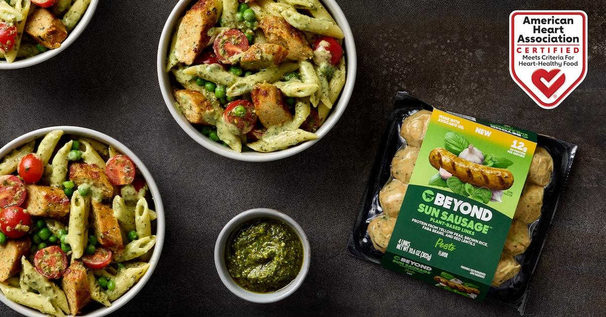 Beyond Meat Sun Sausage in pesto flavor package next to bowls of pasta