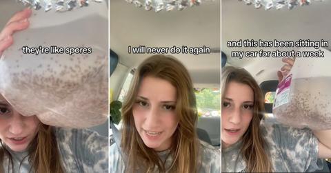 Young woman holds up moldy water bottle