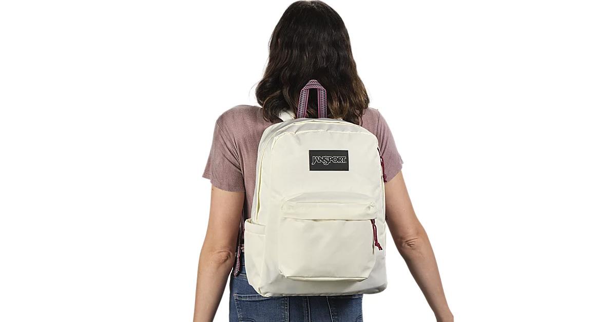 Student wearing a cream-colored Jansport backpack