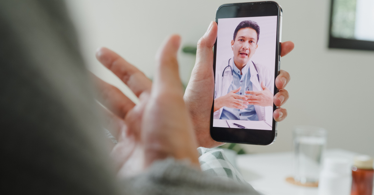 Closeup of a person talking to their doctor on a telehealth call